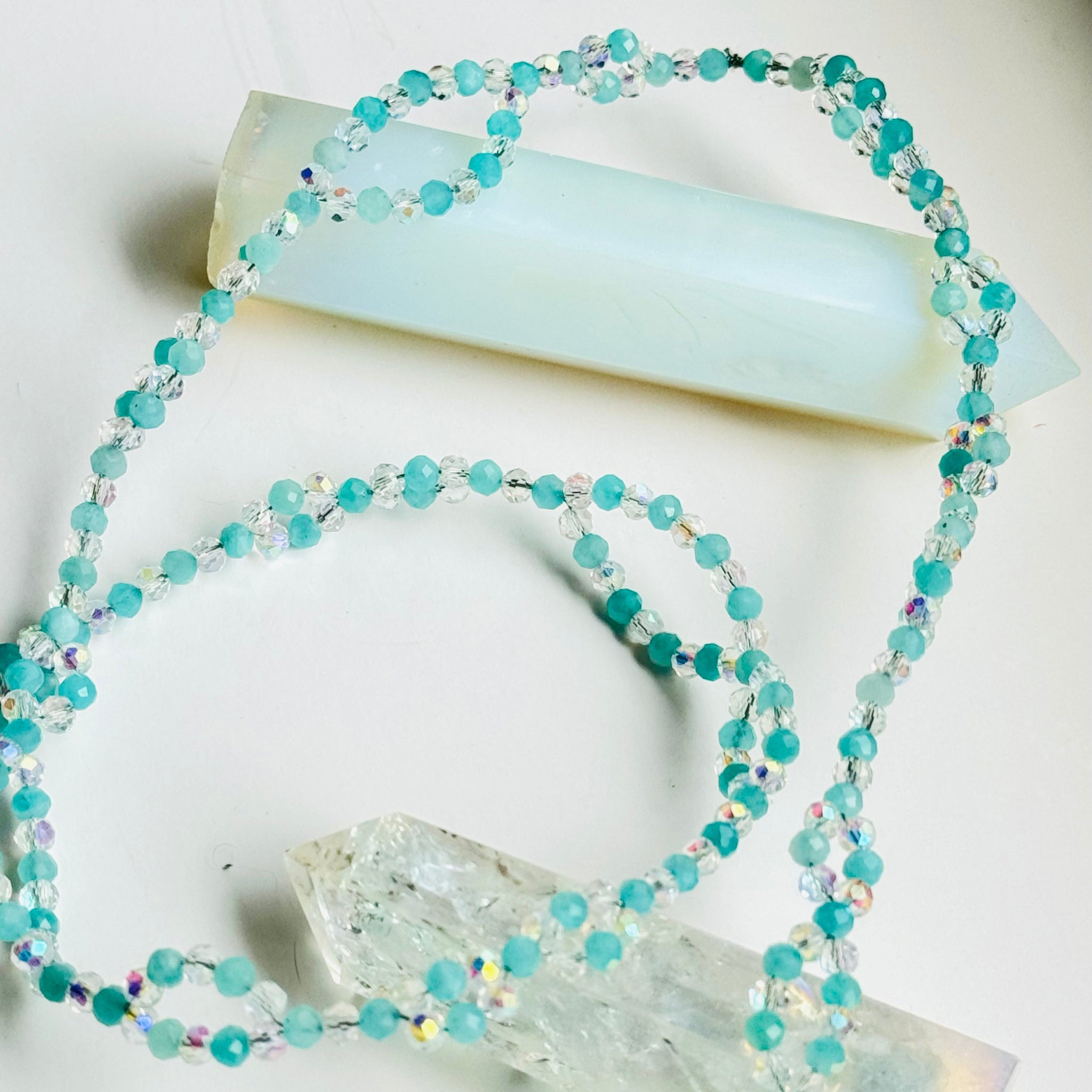 Amazonite Tantric Necklace on white surface and white crystals
