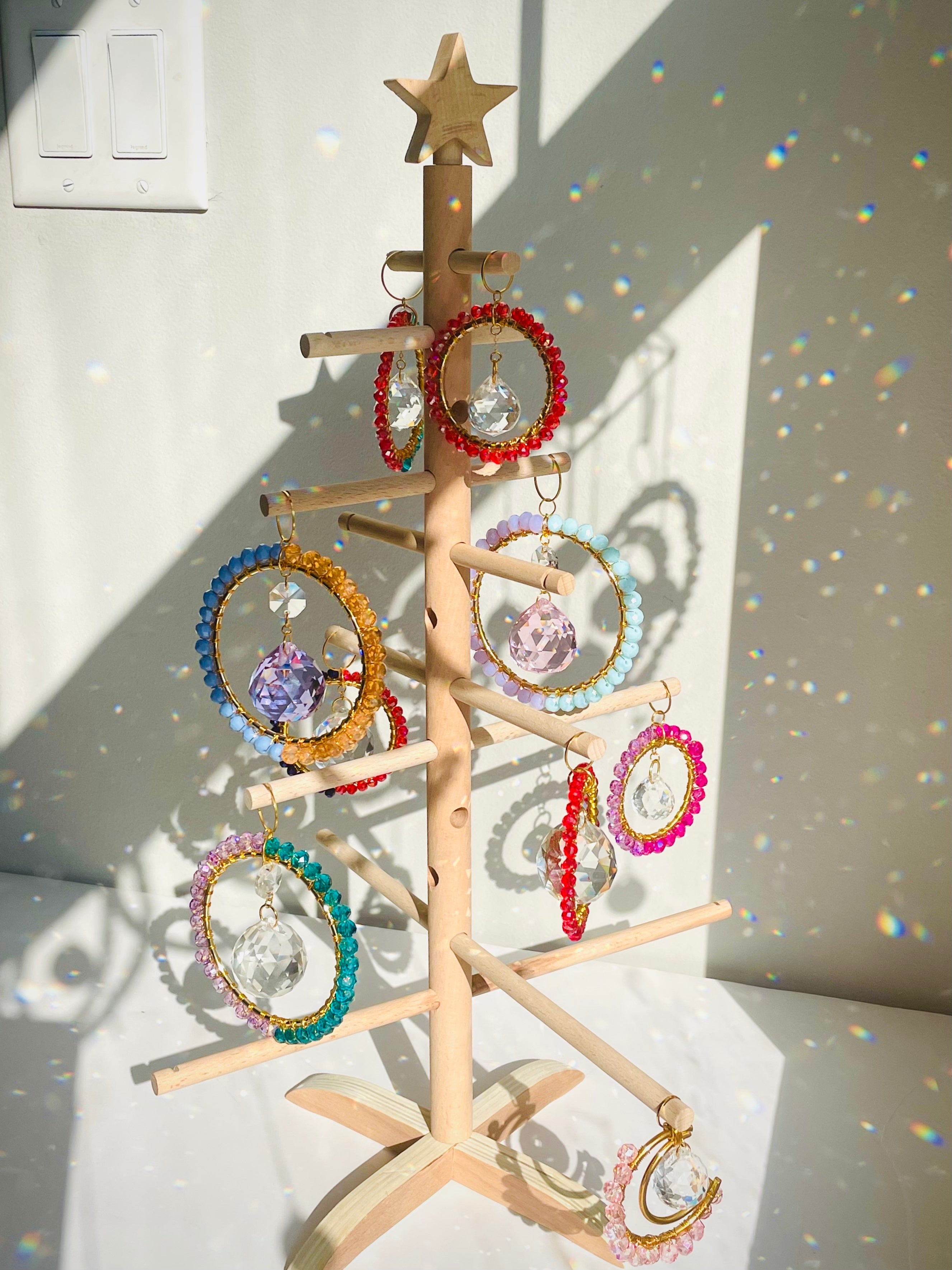 crystal ornaments on wooden shristmas tree