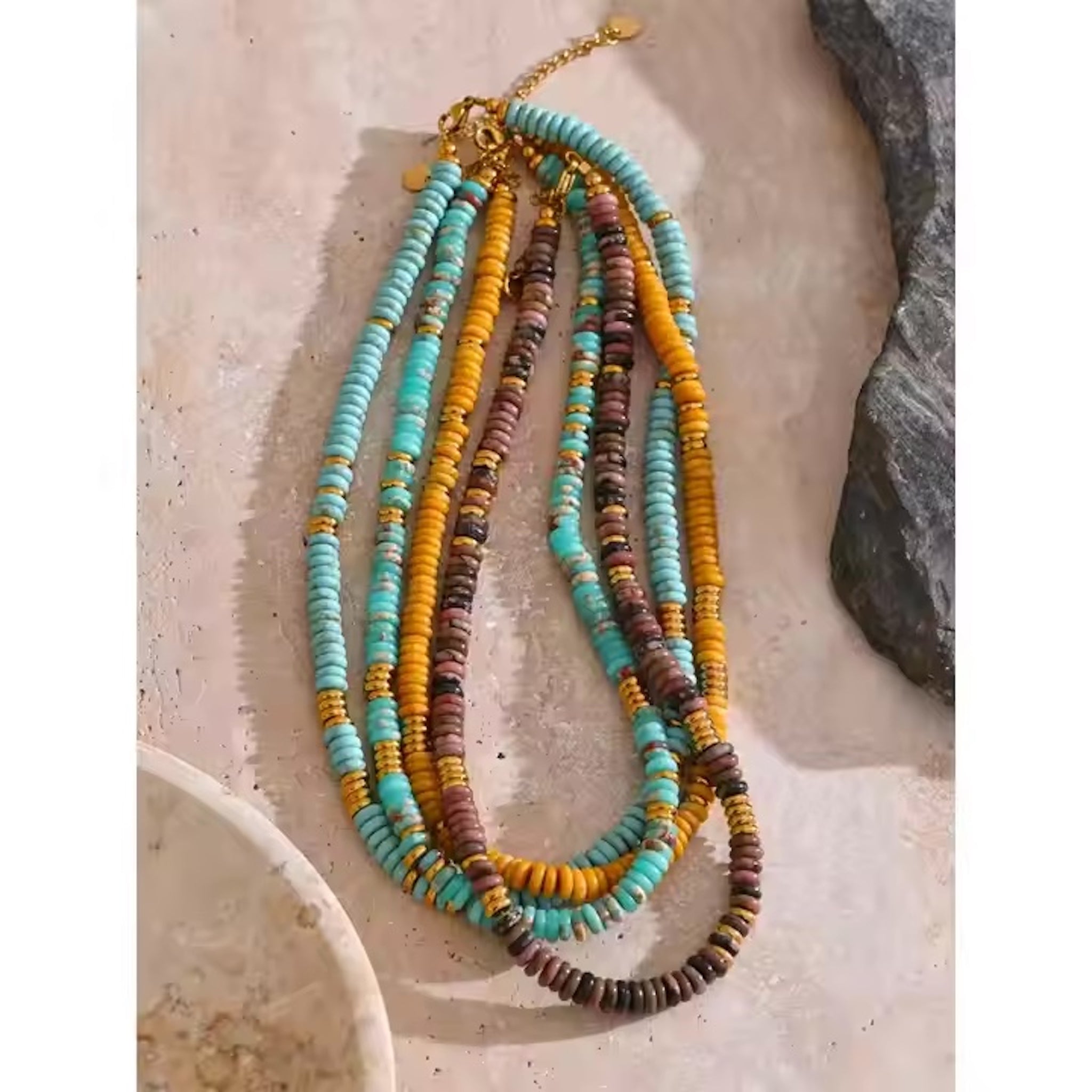 Multicolored beaded necklace on a textured surface