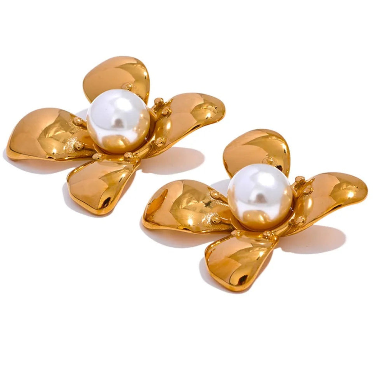 A pair of gold-colored flower-shaped pearl earrings with the central pearl removed to show the intricate flower design.