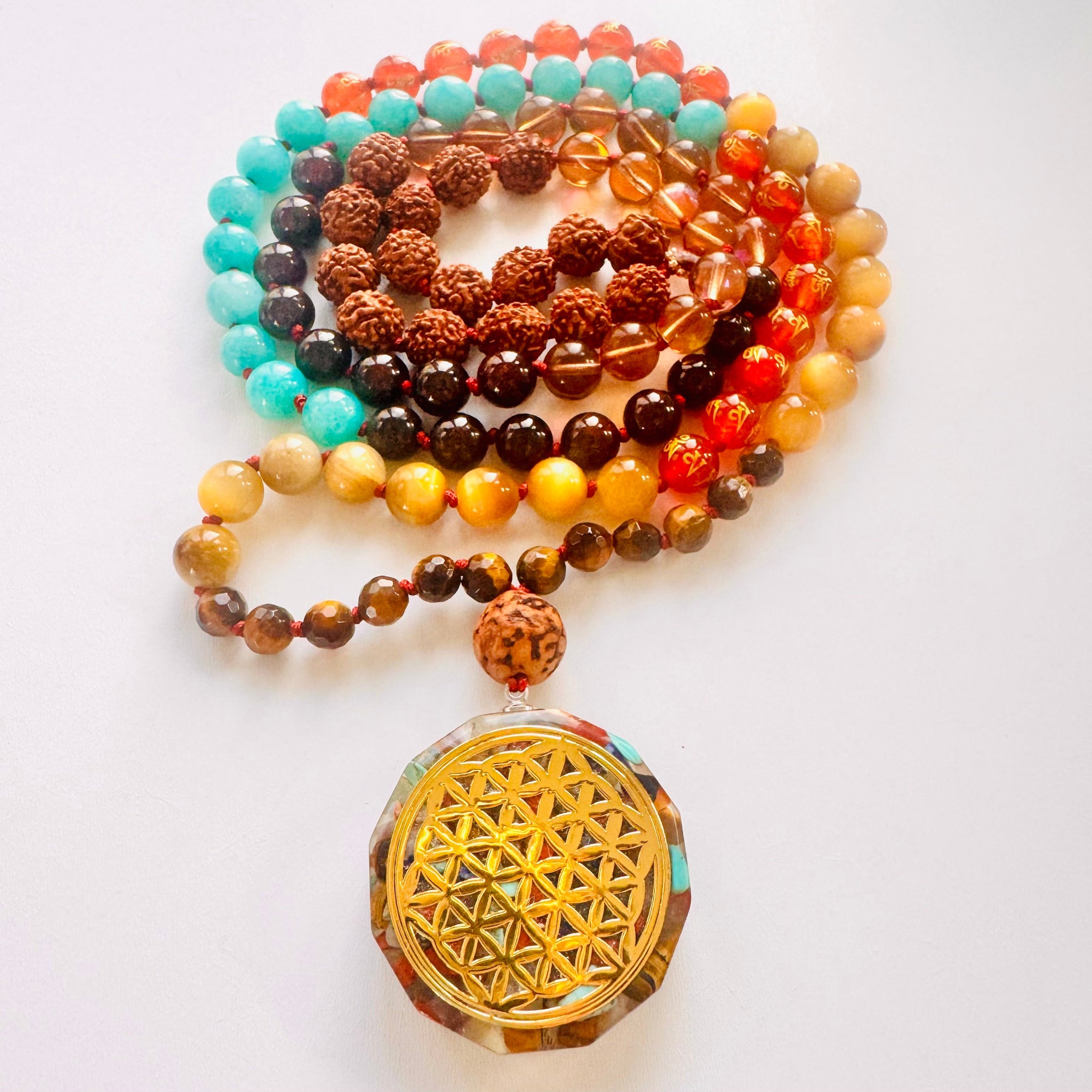 Colorful beaded necklace with a gold pendant on a white background