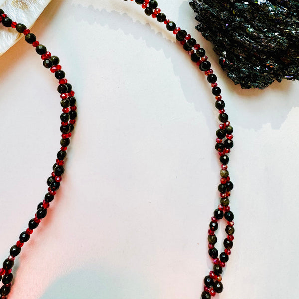 black and red gemstone tantric necklace closeup photo with black crystal as decor