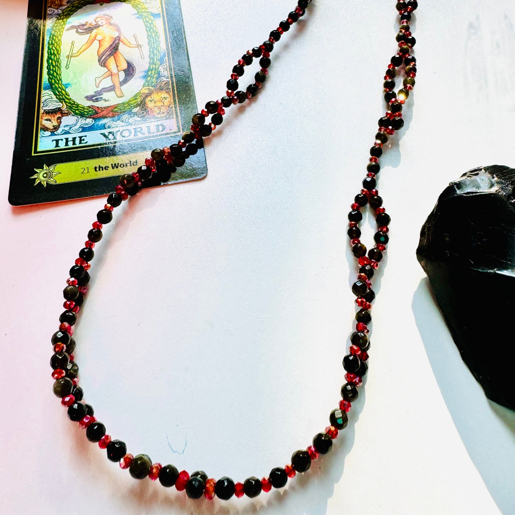 Black and red bead tantric necklace with black crystal and arcana card as a decor