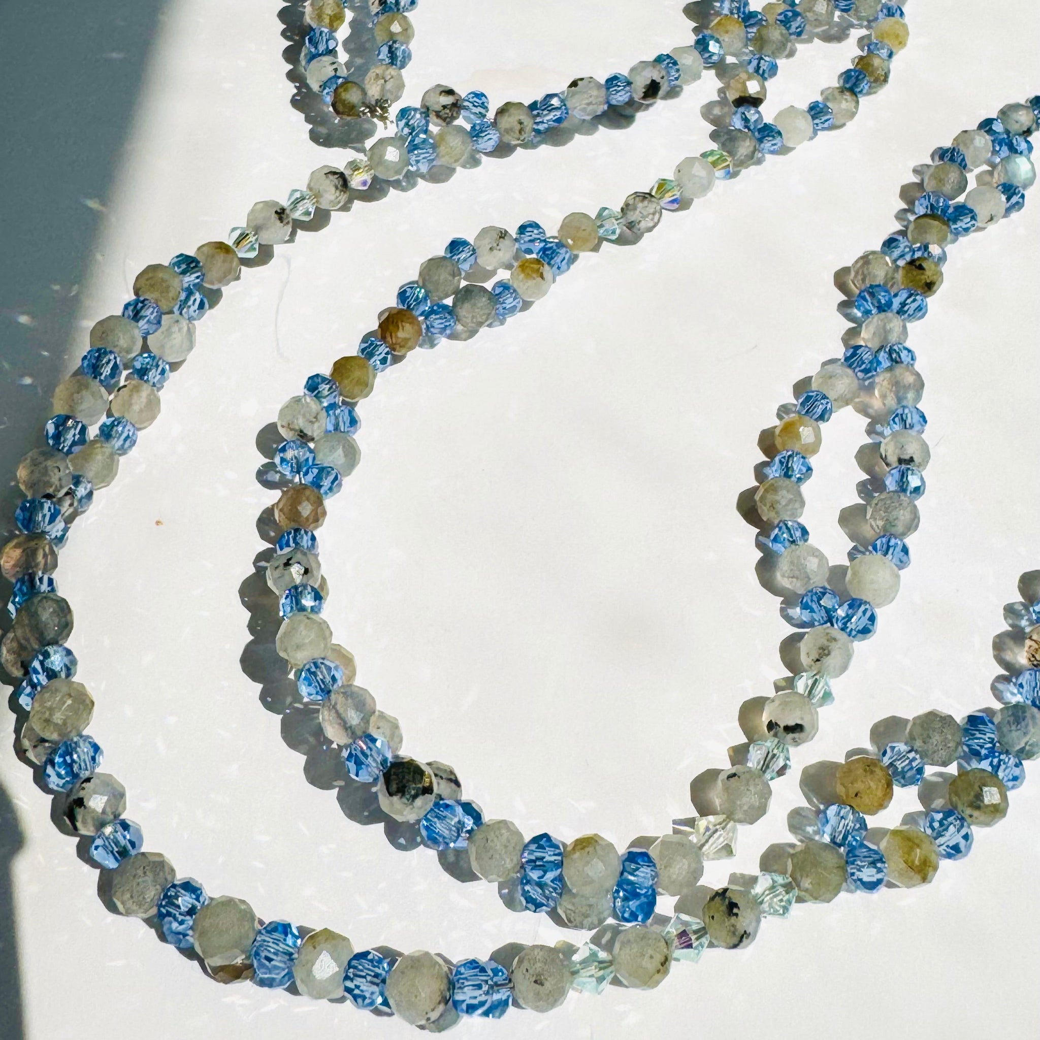 Moonstone beaded tantric necklace closeup photo on white surface