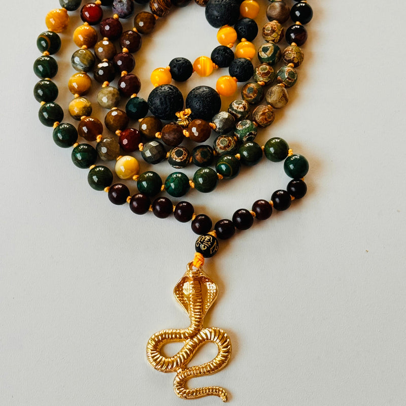 Closeup image of kundalini shakti mala beaded black and gold gemstones with serpent pendant
