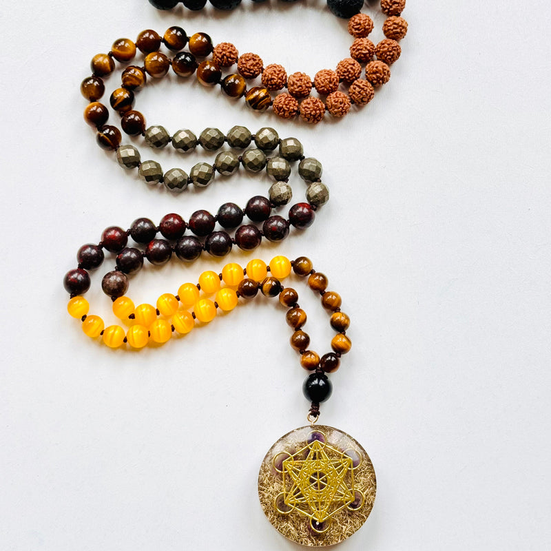 A beaded mala necklace with a Metatron's Cube pendant, featuring various colored beads and a gold-colored pendant.