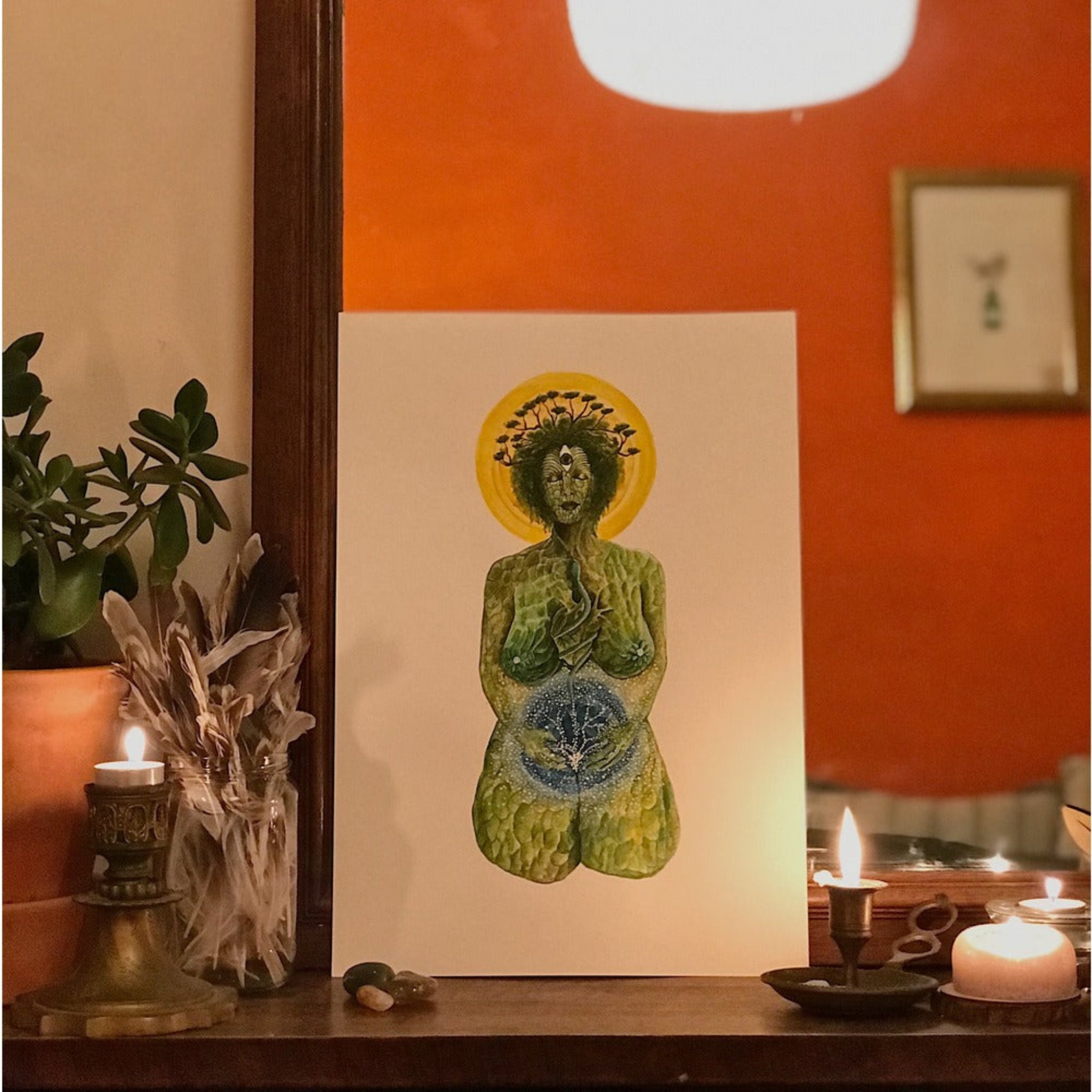 Artistic depiction of a figure with a yellow halo on a white background, surrounded by candles and plants. 