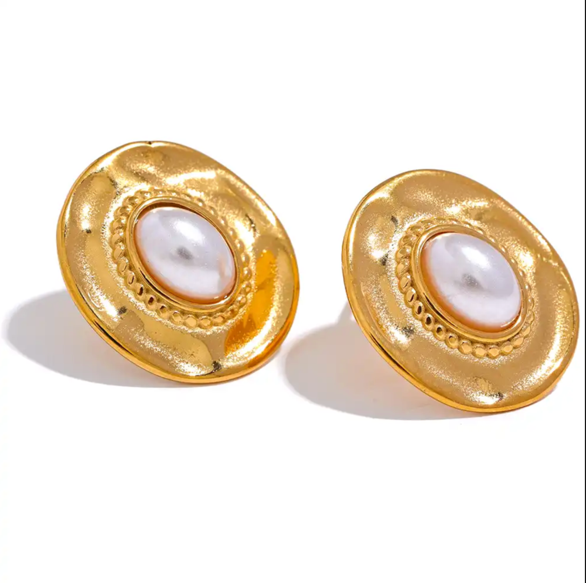 Pearl stud earrings in white surface