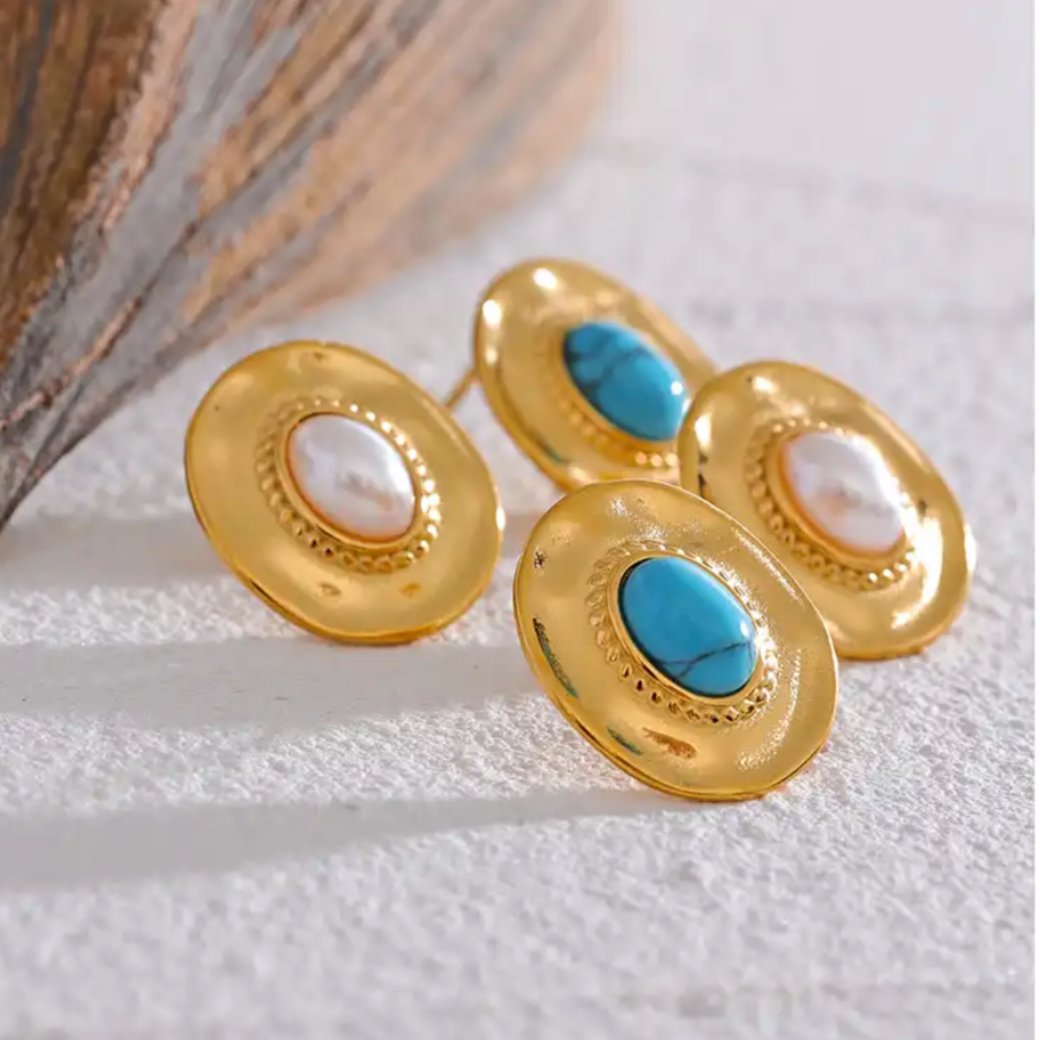 Pearl and Turquoise stud earrings on surface