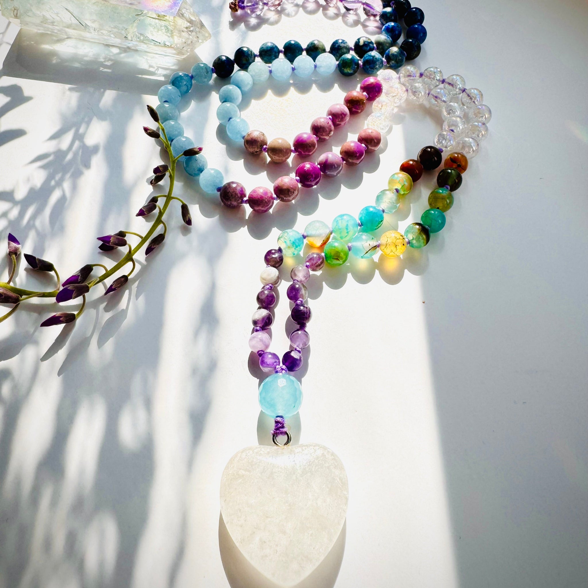 Pure Heart Mala on white surface with flower and crsytal