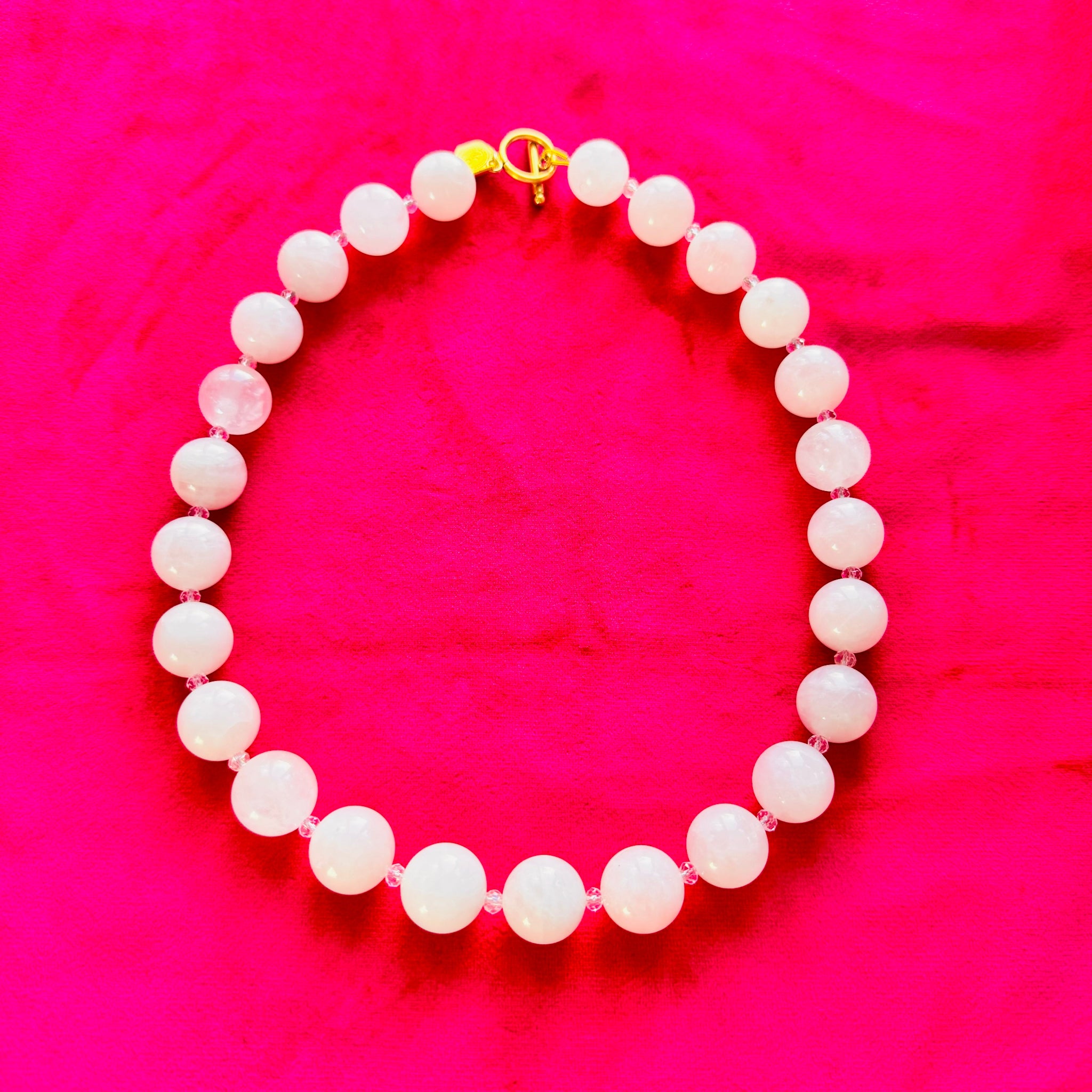 Rose Quartz necklace on a bright pink background
