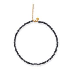 A black hematite necklace with a gold plated sterling silver lobster clasp closure.