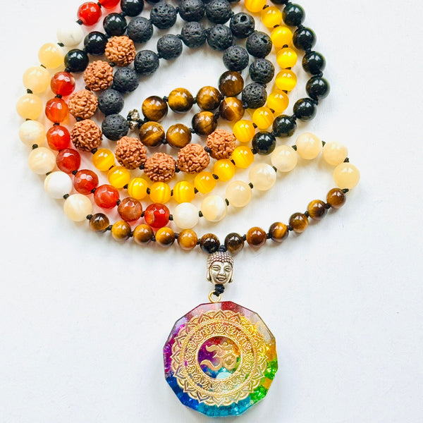 A variety of colorful gemstone beads and  Om orgonite pendant in spiral.