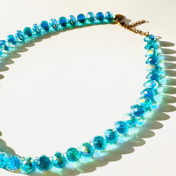 Necklace with blue beads on a white background