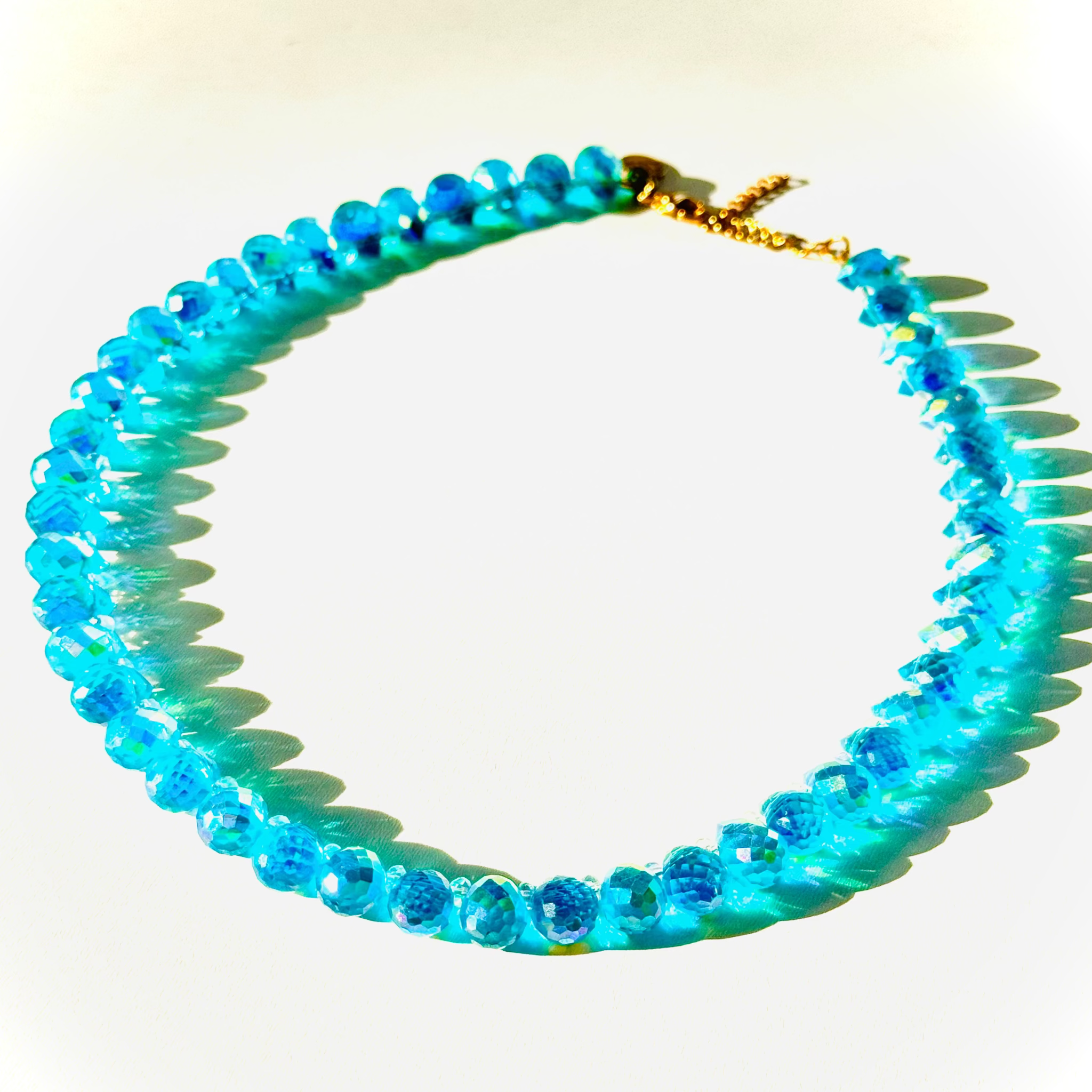 Blue beaded necklace on a white background