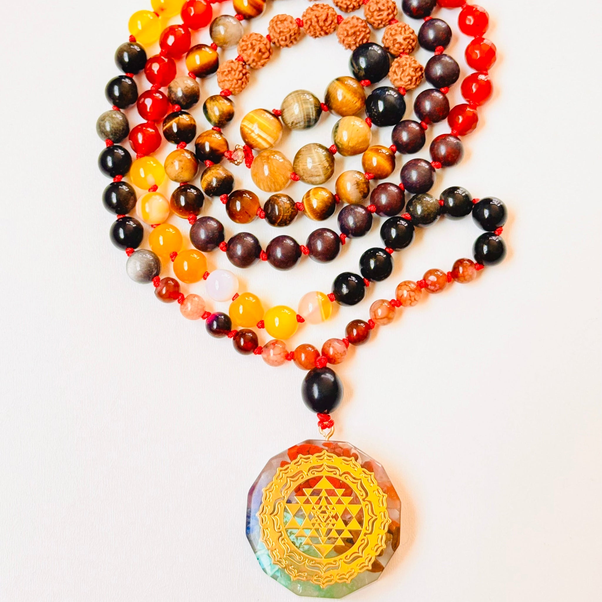 Colorful beaded necklace with a large yellow pendant on a white background