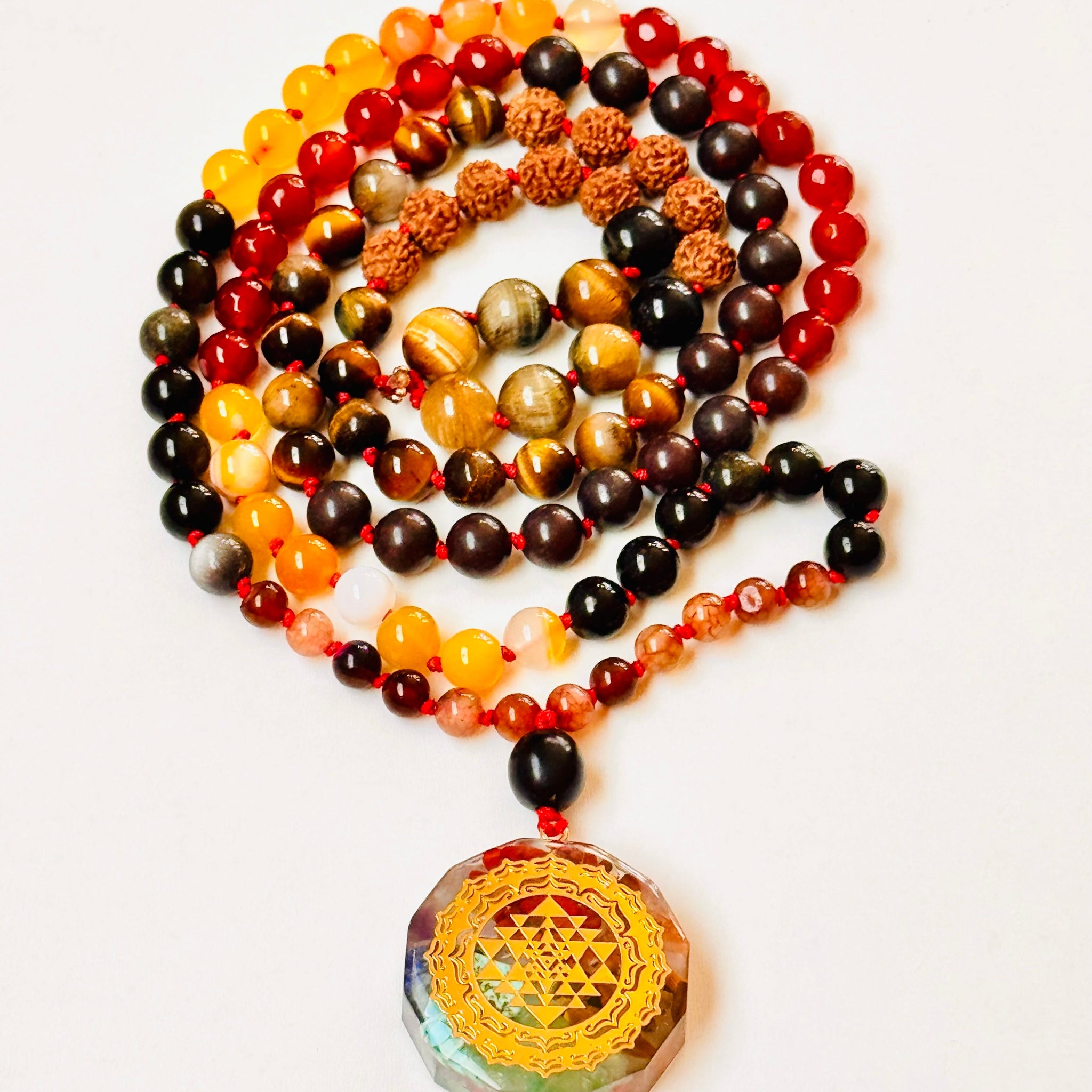 Colorful beaded necklace with a gold pendant on a white background