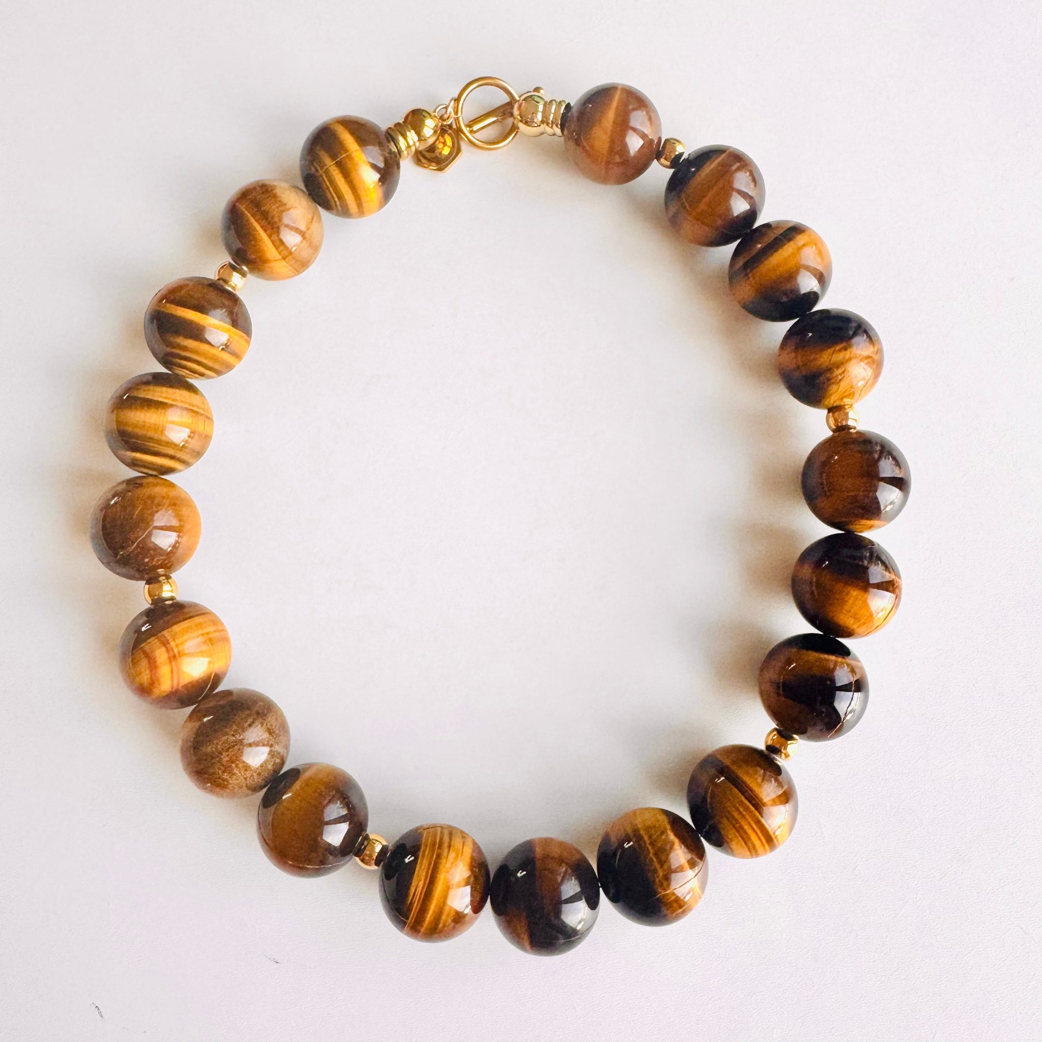 Necklace with tiger eye beads on a white background