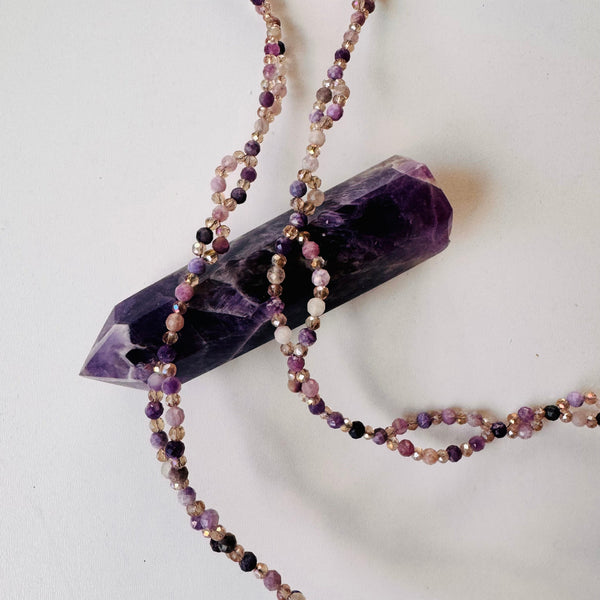 closeup photo of Lepidolite Tantric Necklace on purple crystal