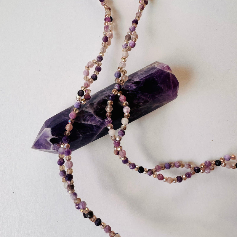 closeup photo of Lepidolite Tantric Necklace on purple crystal