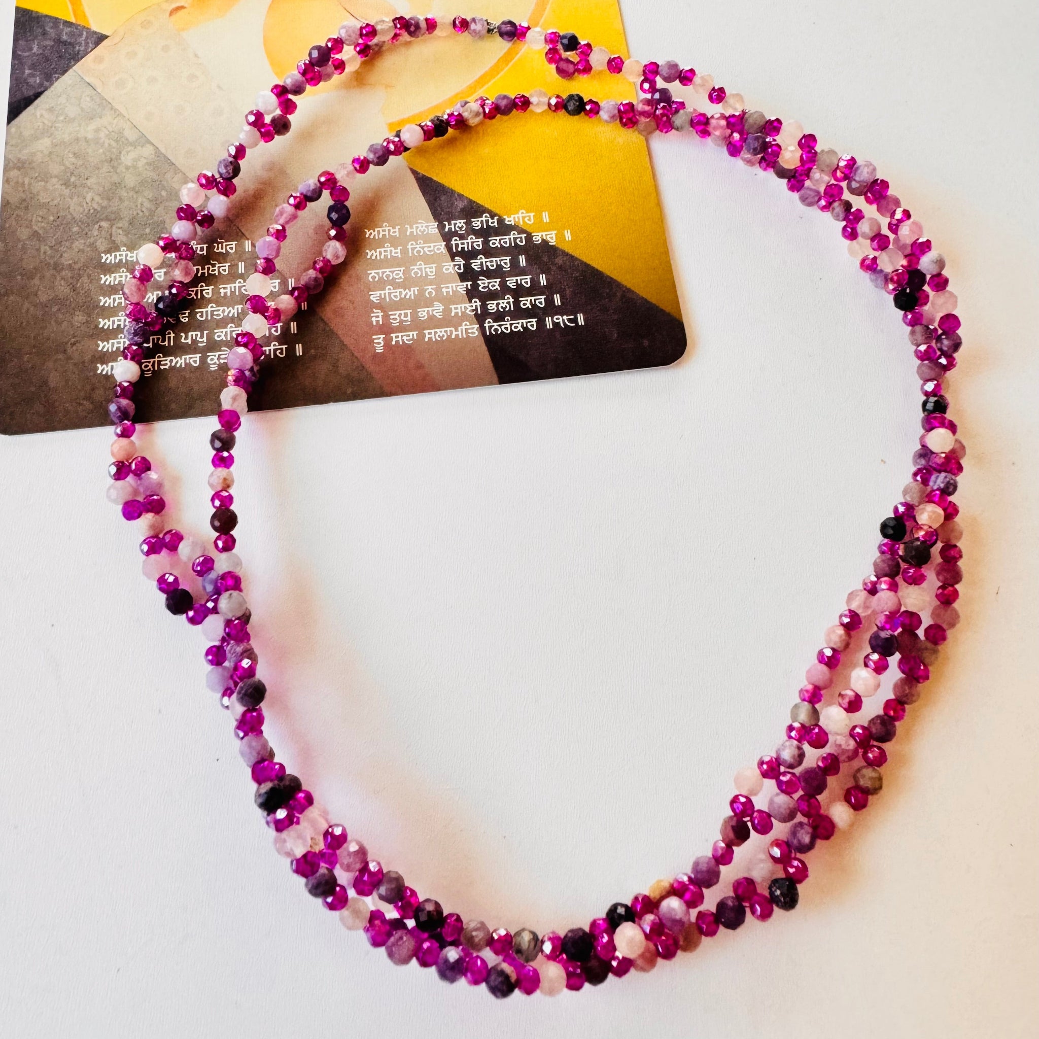 Lepidolite Tantric Necklace white surface with a mantra card
