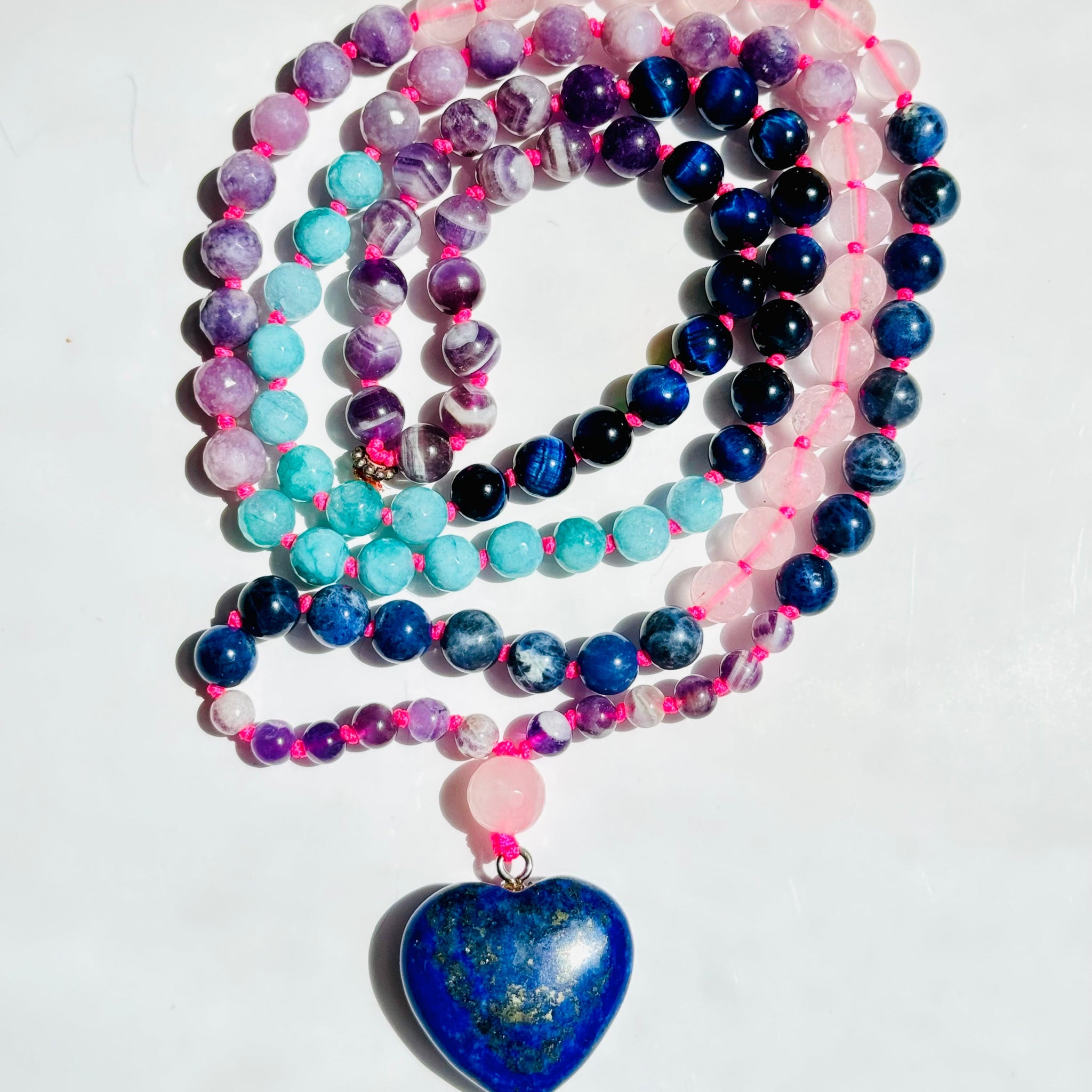 beaded pink and blue gemstones with heart shaped blue pendant