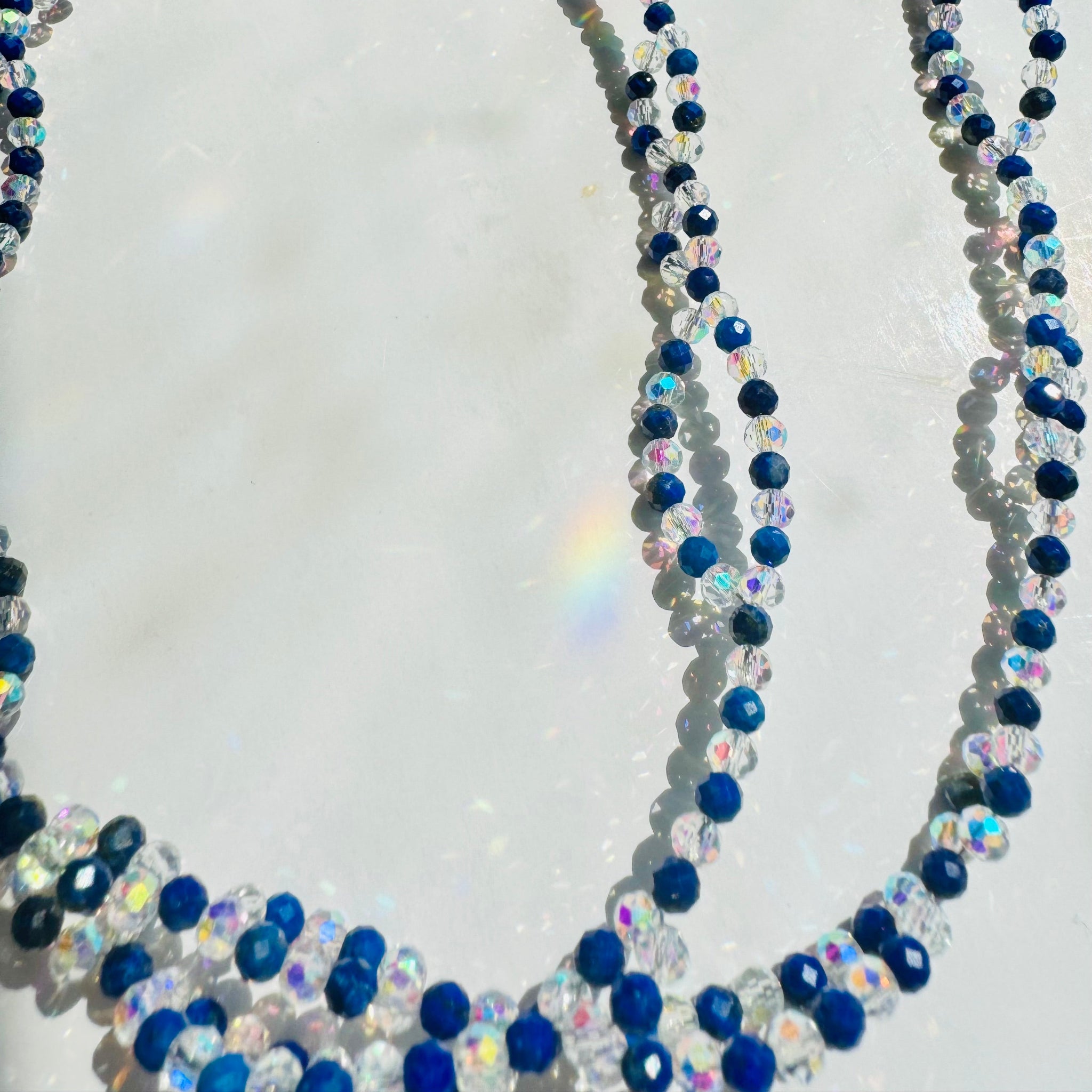Lapis Lazuli tantric necklace closeup photo on white surface