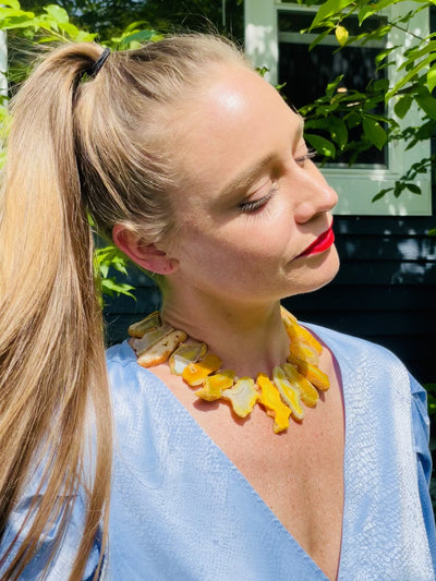 video of a woman wearing yellow agate necklace