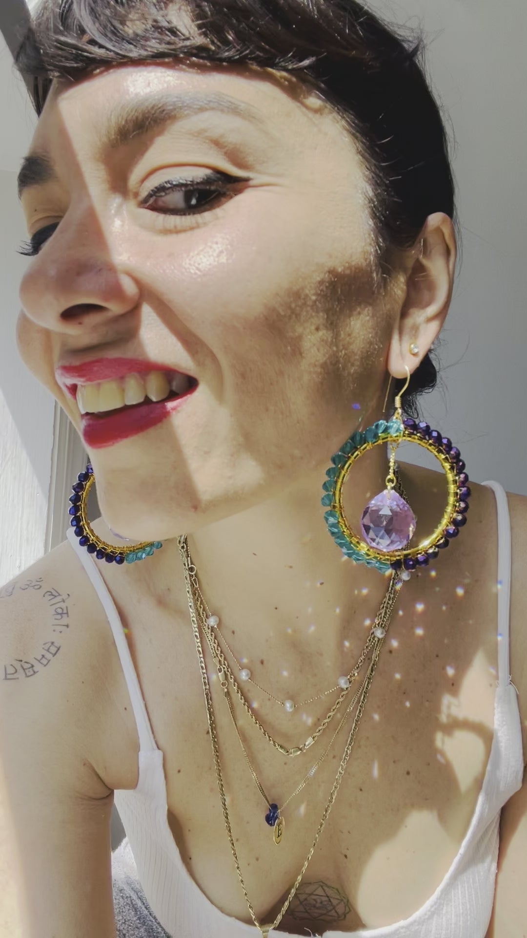 model wearing Magnetic earrings and creating sparkles by the reflection of the sun