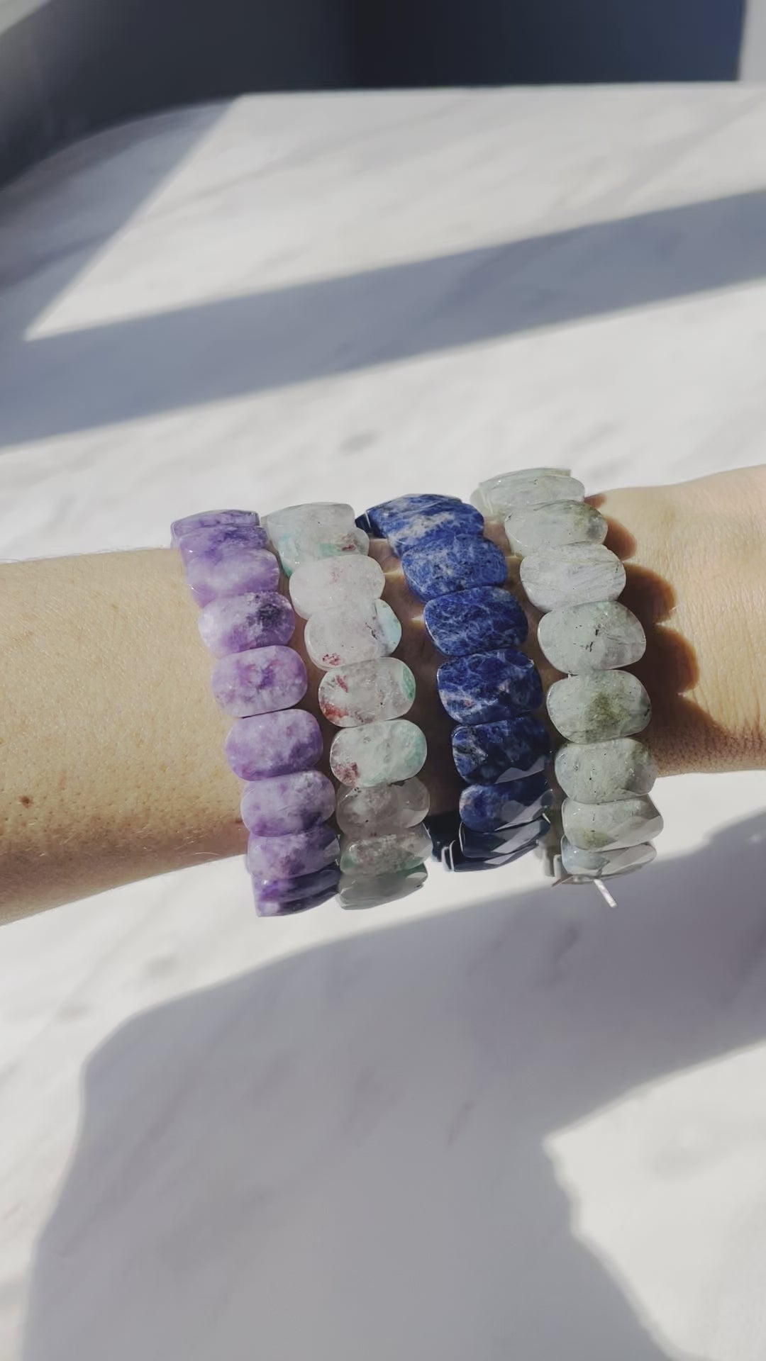 video of model wearing purple blue bracelets