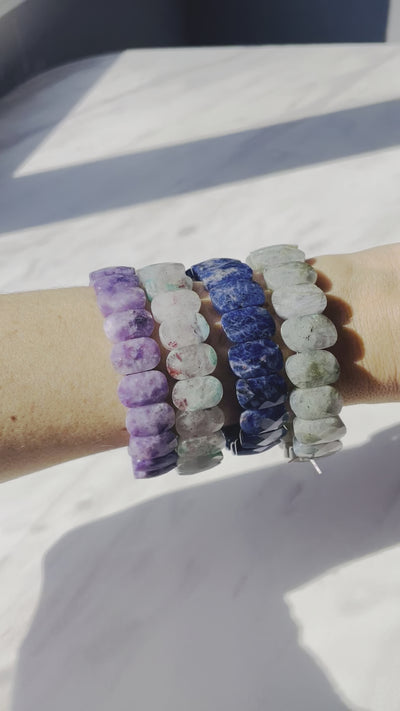 video of model wearing purple blue bracelets