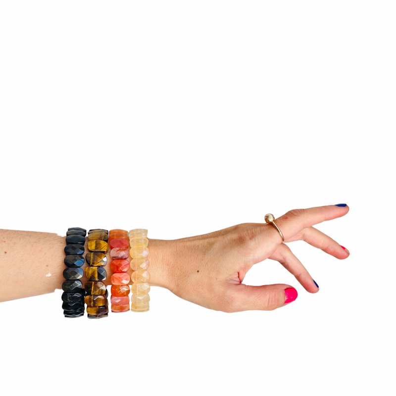 model wearing balck brown orange yellow gemstone bracelets