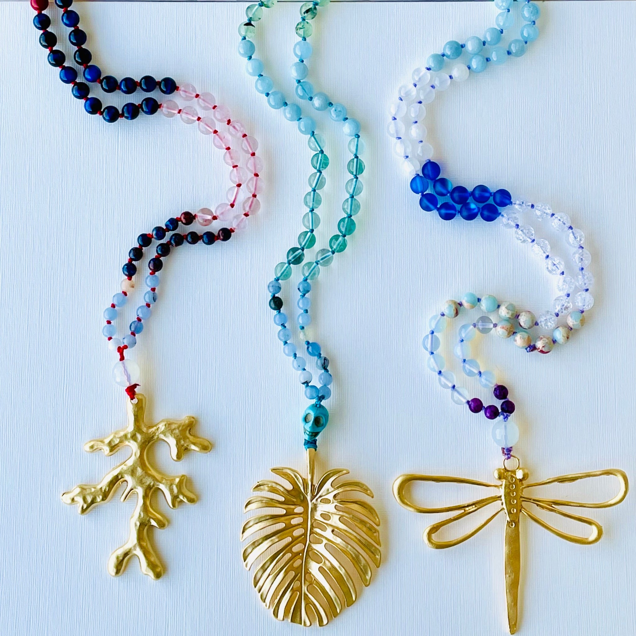 colorful beaded necklaces on white surface