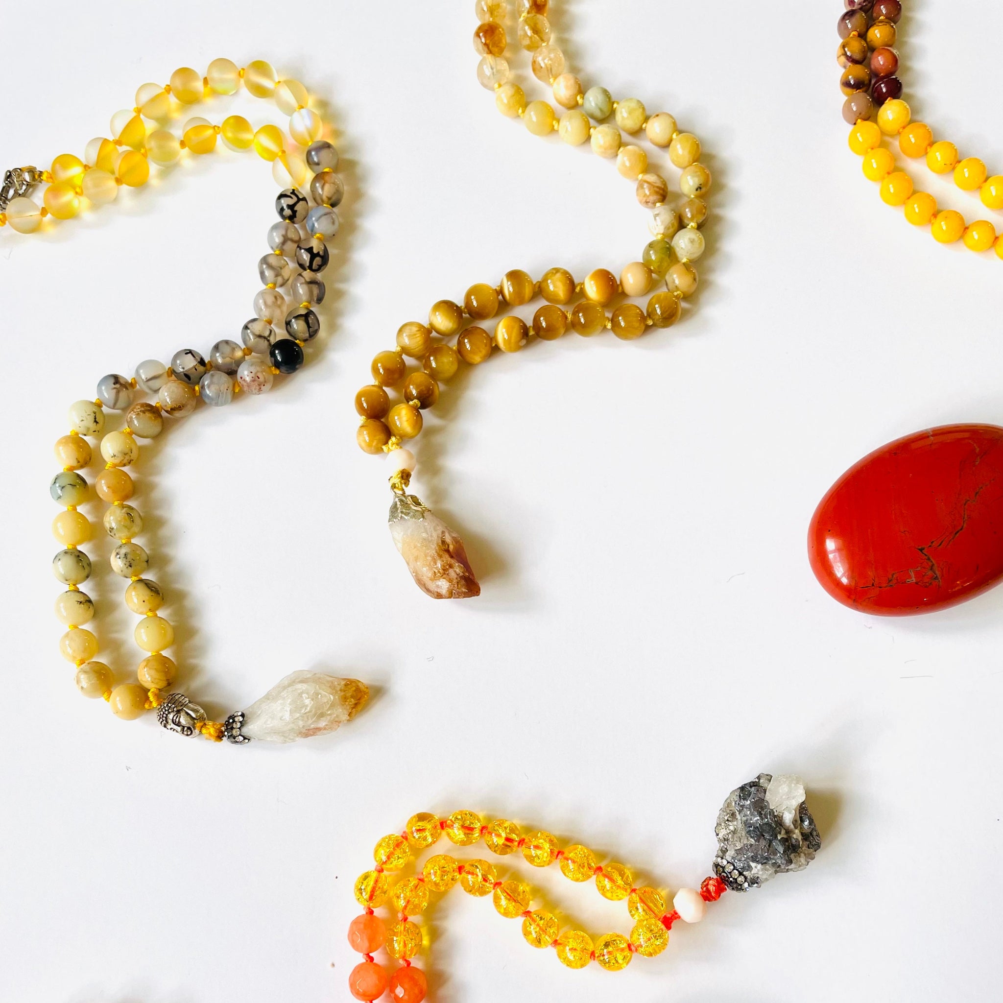 Beaded necklaces with various colored beads on a white background