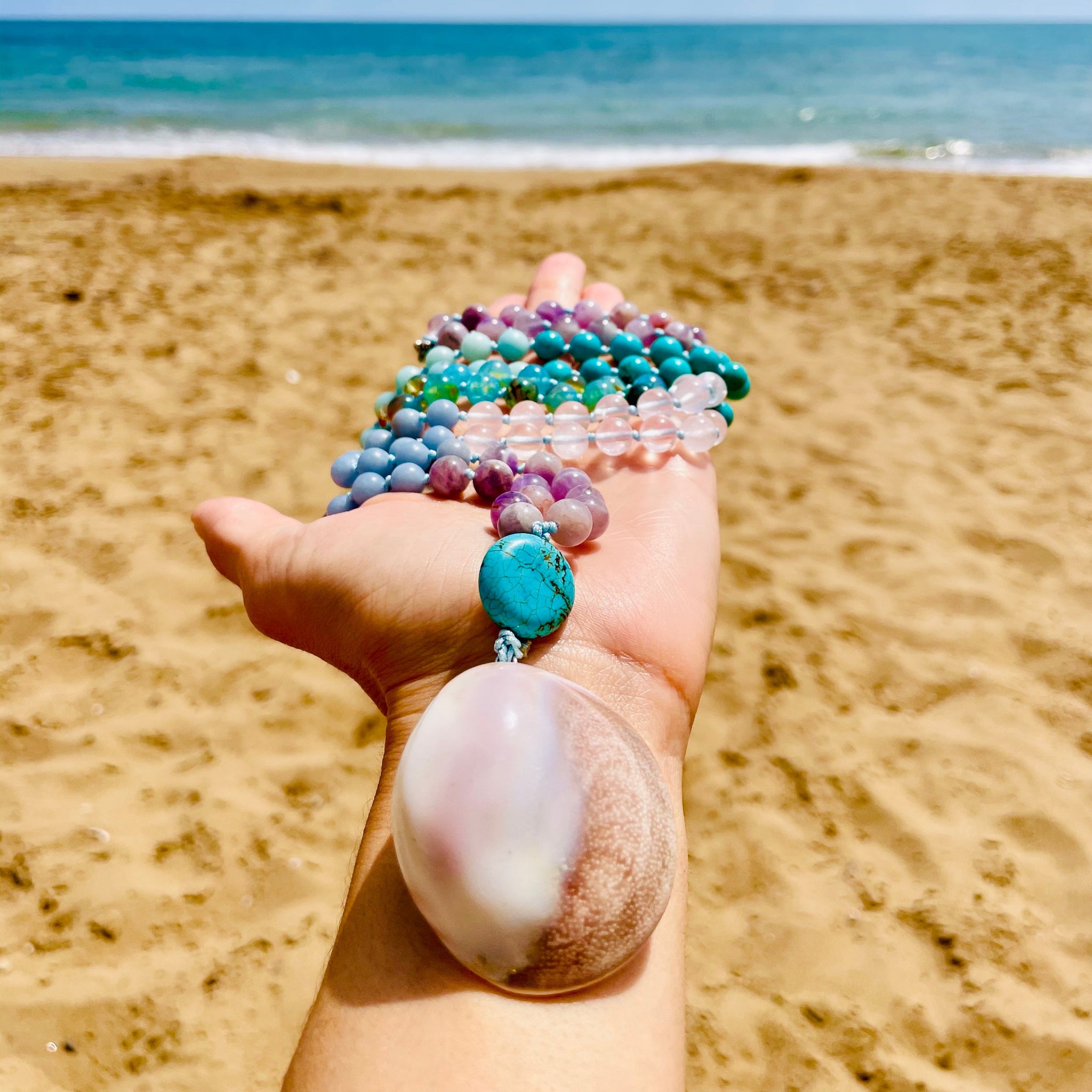 eternal mala photo taken near the beach with sea and sand