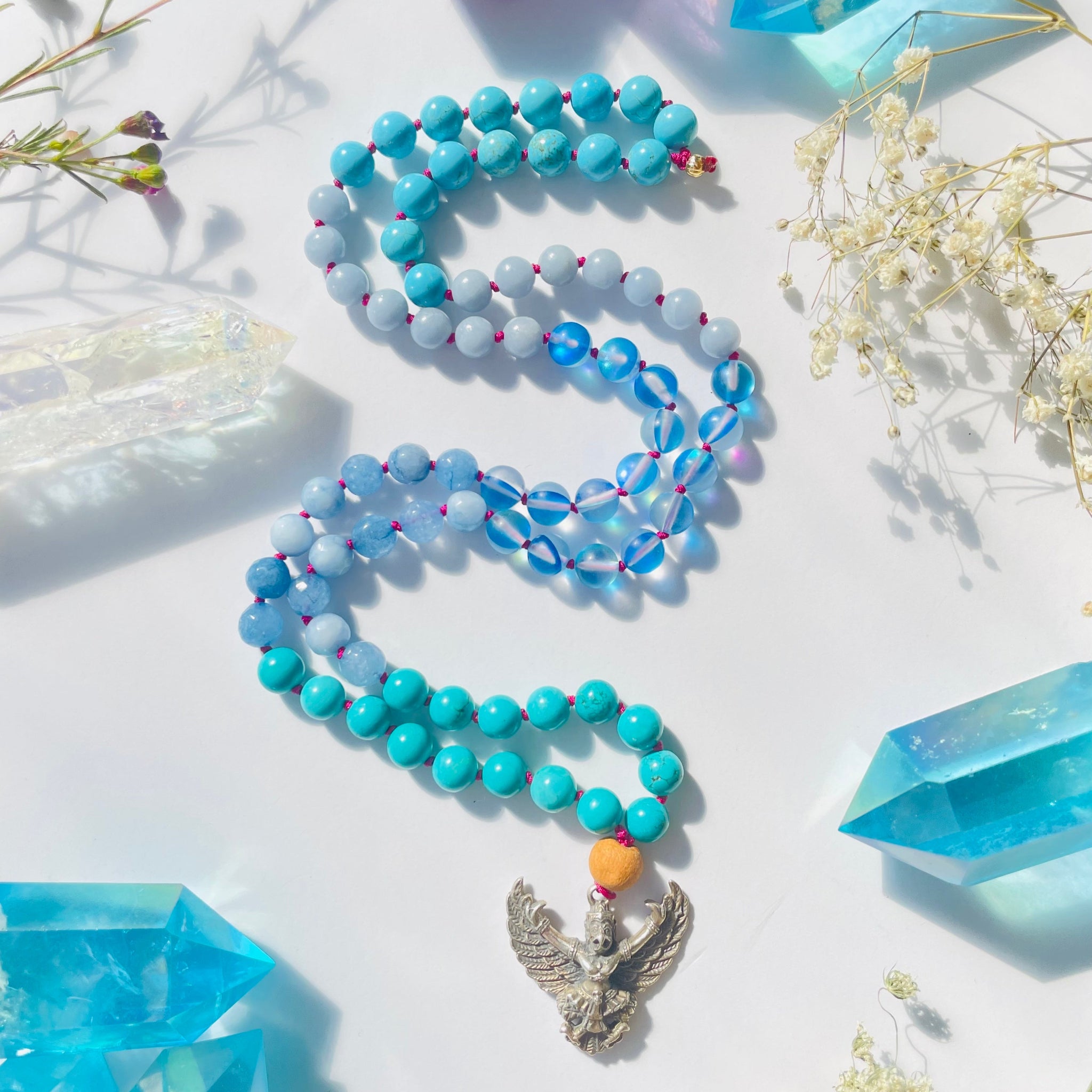 Beaded blue gemstone necklace with Garuda brass pendant