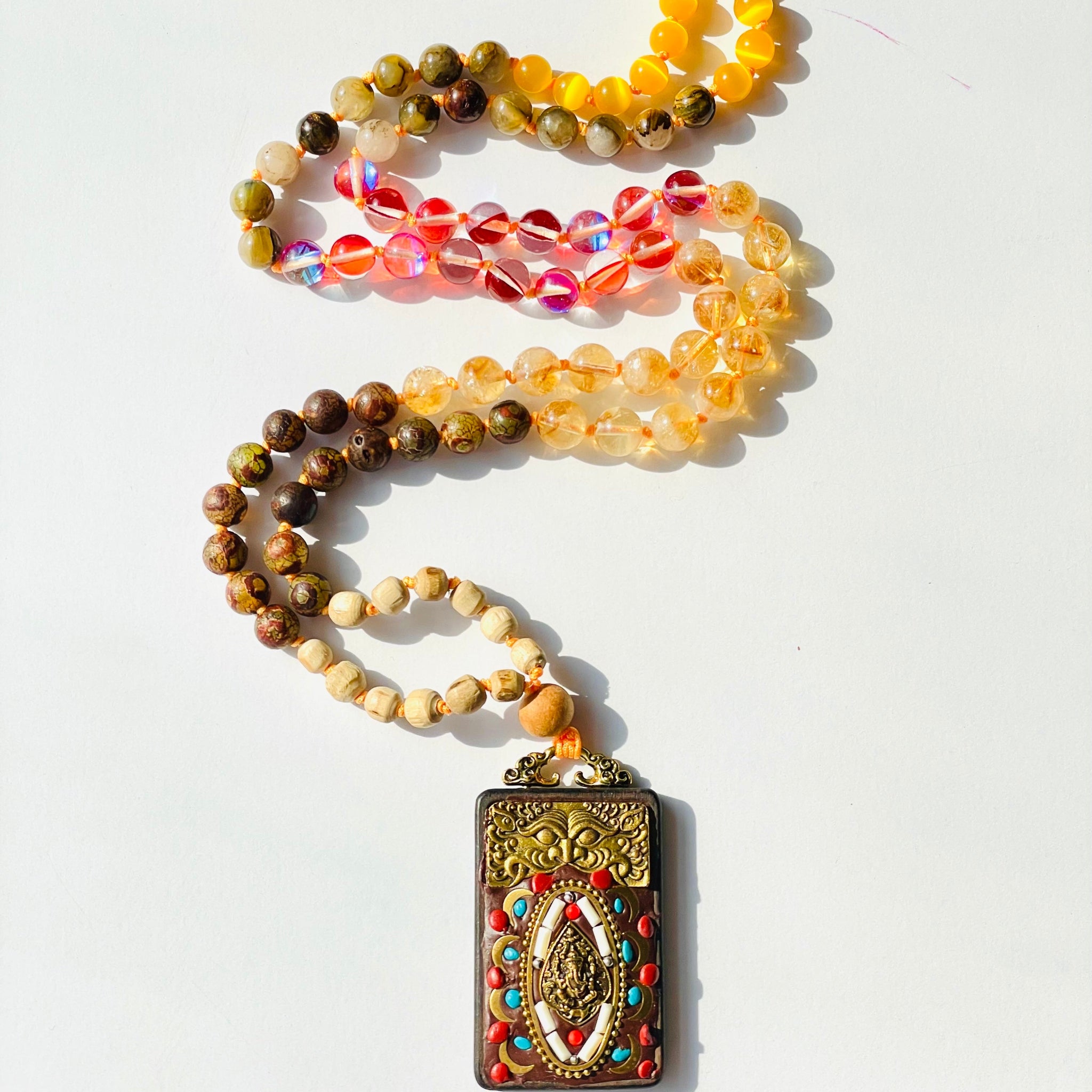 beaded yellow and brown gemstones with buddha wood pendant