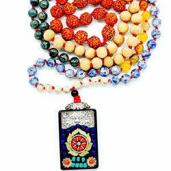 A multicolored beaded mala with a Ganesha bead accent, featuring a red knot and a metal pendant with a Ganesha image.