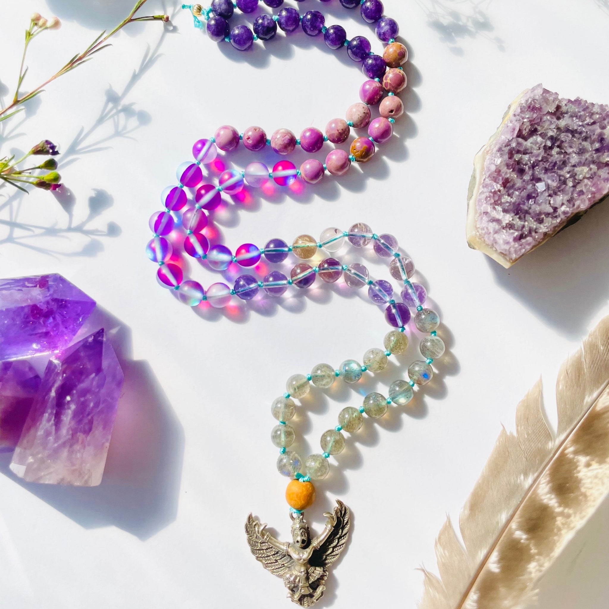 beaded purple and lavender necklace with bird deity pendant