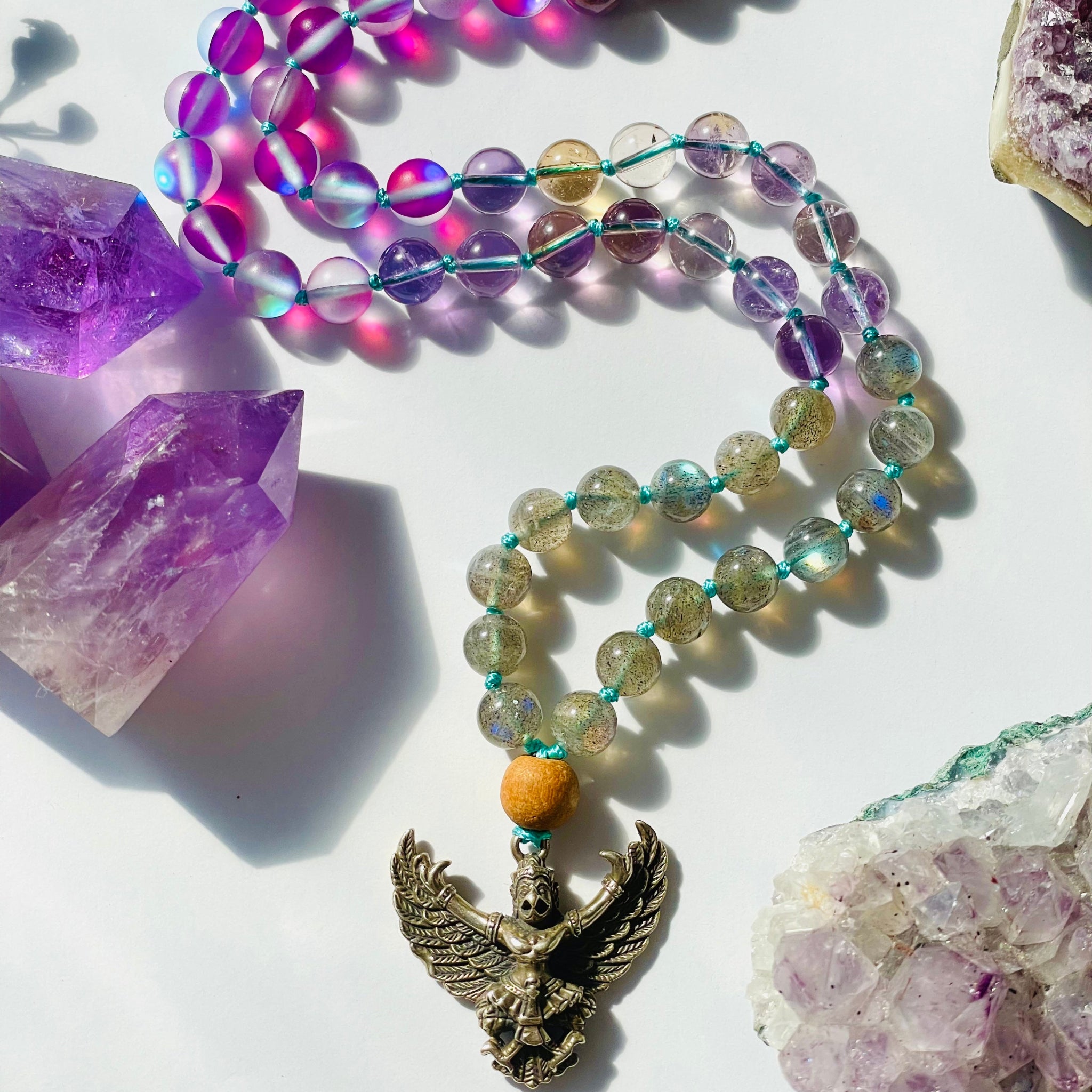 beaded purple and lavender necklace with bird deity pendant