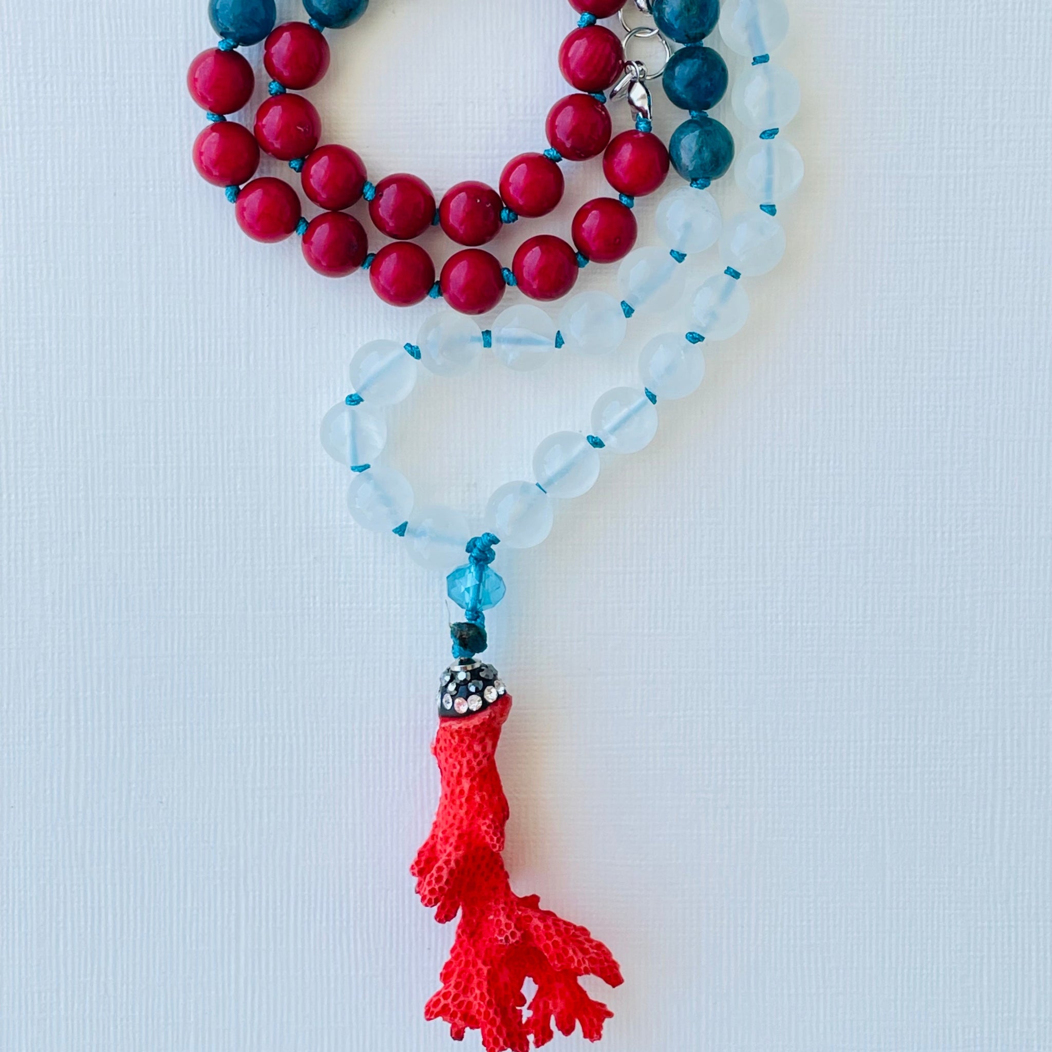 beaded red blue and white gemstones with red coral pendant