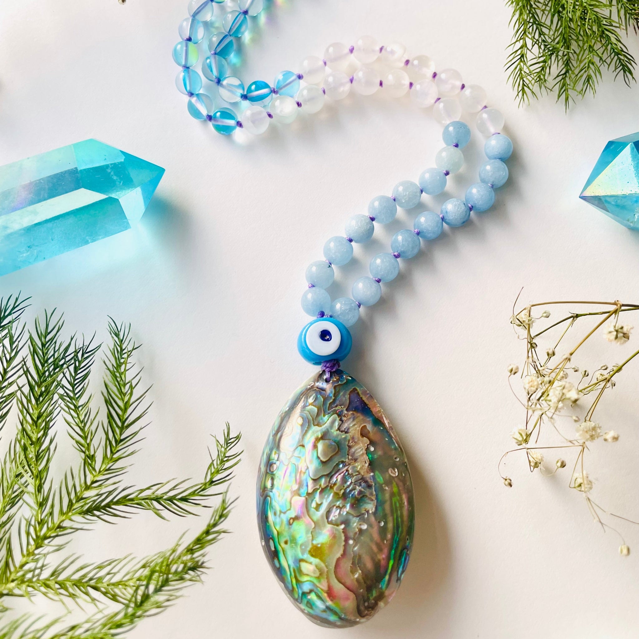 Beaded blue gemstone necklace with shell pendant