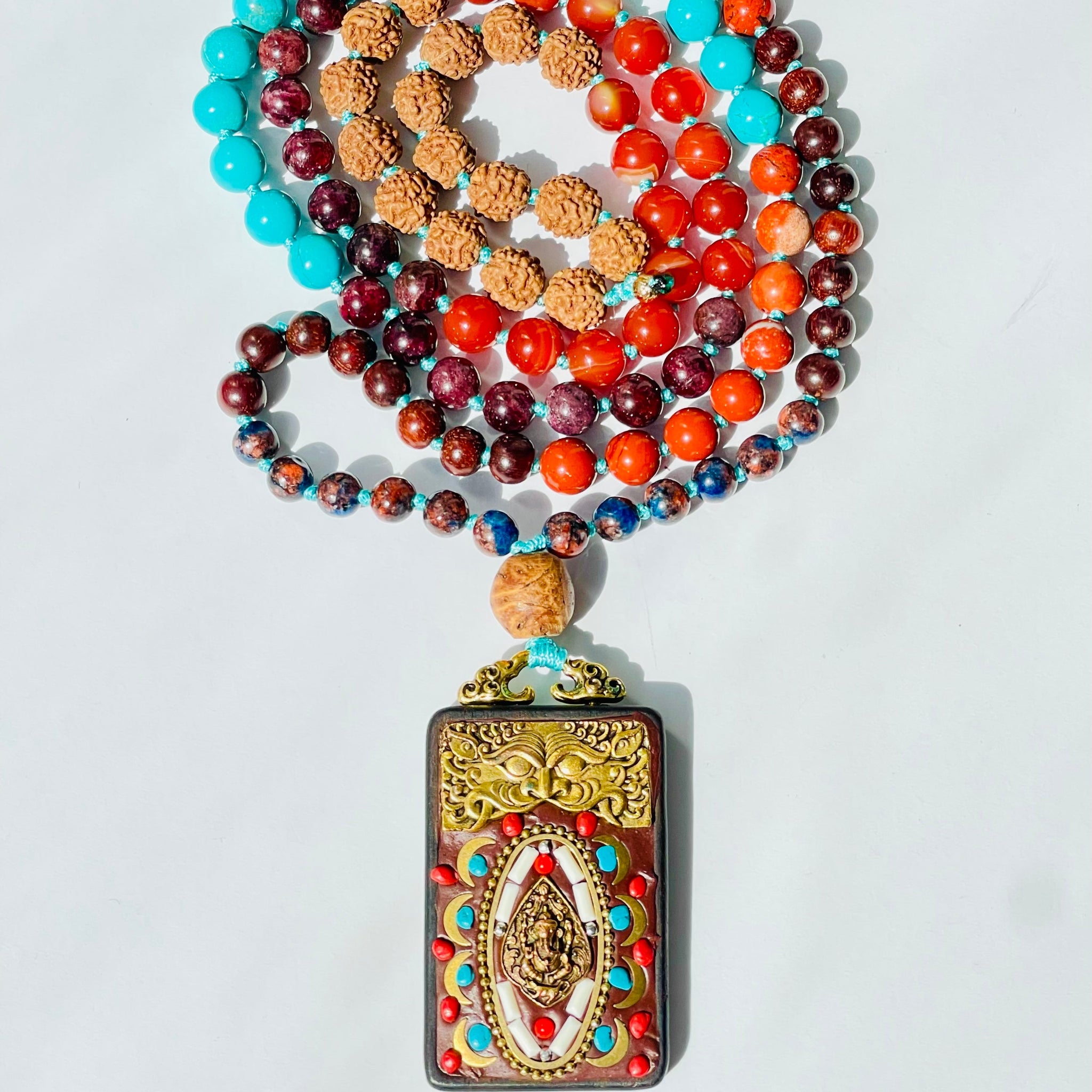 beaded red and blue gemstones with carved elephant pendant
