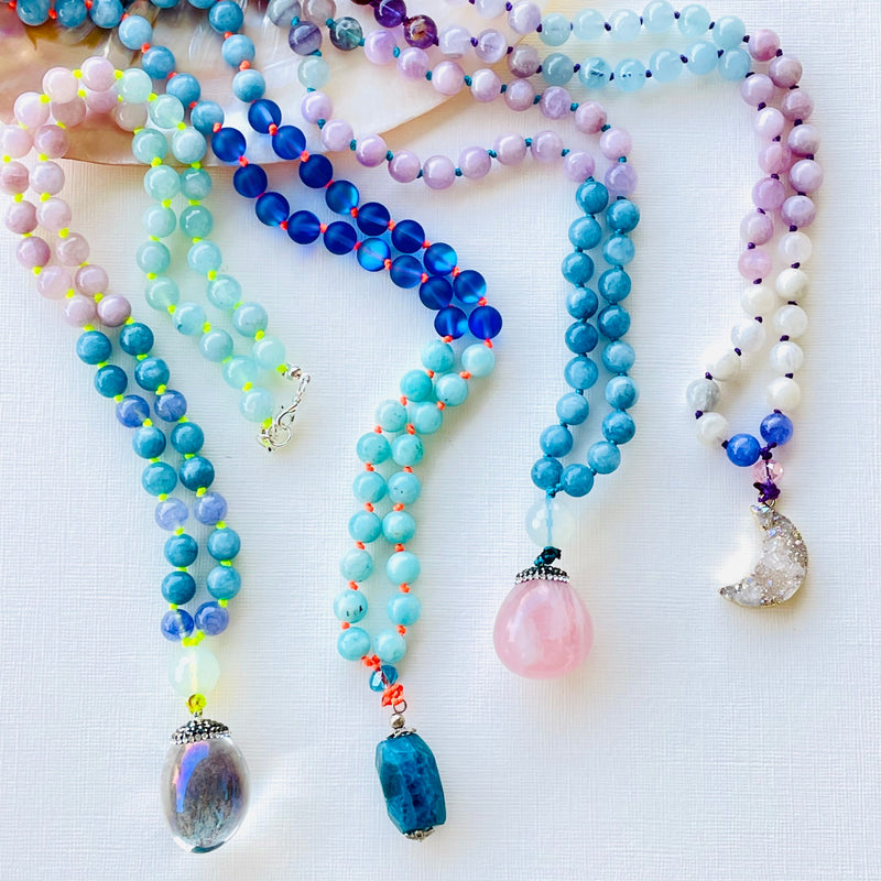 colorful necklaces on white surface