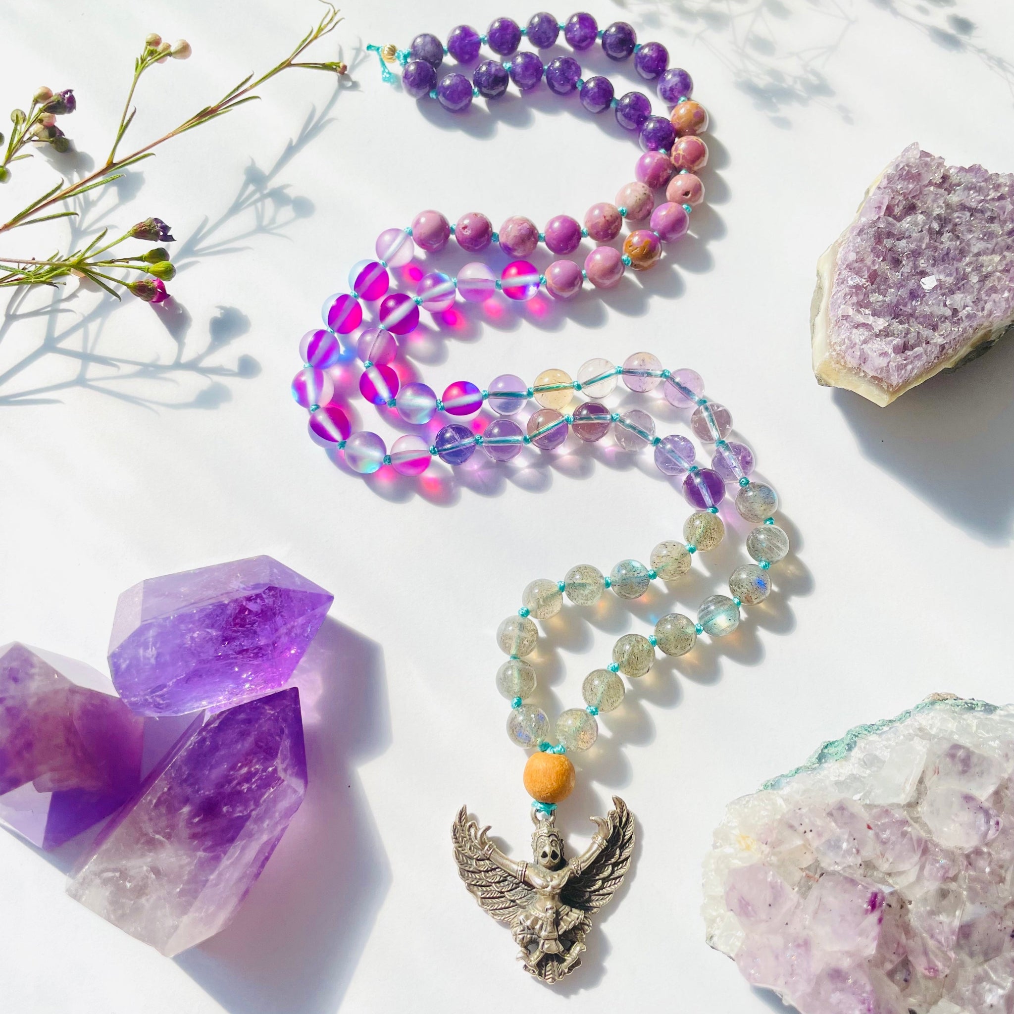 beaded purple and lavender necklace with bird deity pendant